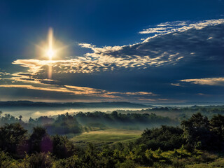 Sunrise and Fog over a valley