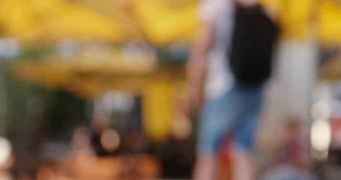 Waiter in blue latex gloves takes away plate with order number serving clients in outdoors cafe on blurred background closeup
