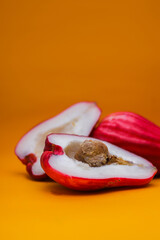 Jambu Bol or Jambu Jamaica isolated on orange background also known as Malay red rose Apple (Syzygium Malaccense).