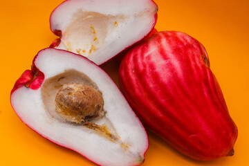 Jambu Bol or Jambu Jamaica isolated on orange background also known as Malay red rose Apple...