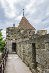Fragments of outer wall (13th century) and towers of the Carcassonne medieval citadel on a hill on...