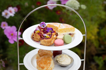 Afternoon tea with cakes, scones and macaroons