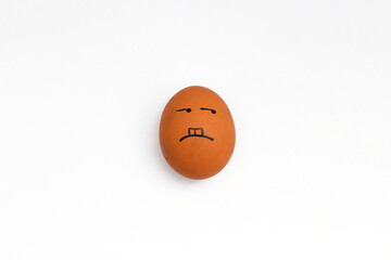 a brown chicken eggs with annoyed face isolated on white background.