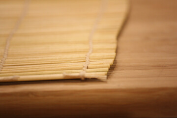 Homemade sushi roll preparation on a bamboo mat – in progress 