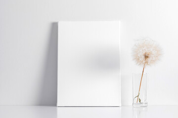White canvas mockup with shadow on wall and dry dandelion decoration
