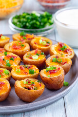 Baked mini red skinned loaded potatoes with crispy bacon, scallions and sharp cheddar cheese