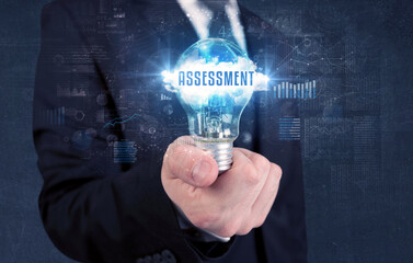 Businessman holding a light bulb, business concept