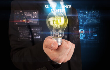 Fototapeta na wymiar Businessman holding a light bulb, online security concept