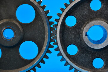Gear wheels on a blue background. Spare parts,