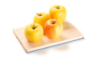 manzana amarilla sobre tabla de cortar de madera. aislada fondo blanco close-up
