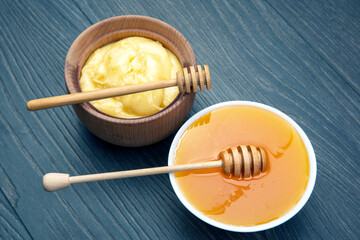 Fresh flower honey of different varieties, pollen and honeycomb with spoons on a wooden background. Organic Vitamin Health Food