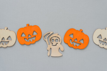 halloween pumpkin with ghost or grim reaper on gray