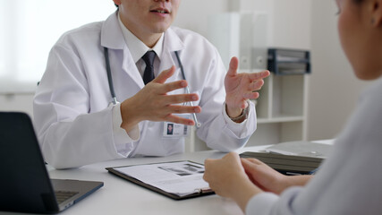 Friendly medic service people or asia male help talk discuss of medical exam record test result at...