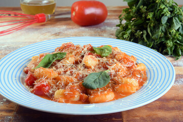 pasta in white sauce with parmesan cheese, tomato, basil, herbs, delicious food from Italian and French cuisine