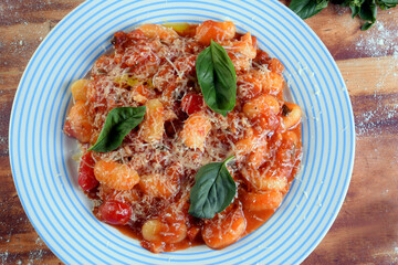 pasta in white sauce with parmesan cheese, tomato, basil, herbs, delicious food from Italian and French cuisine