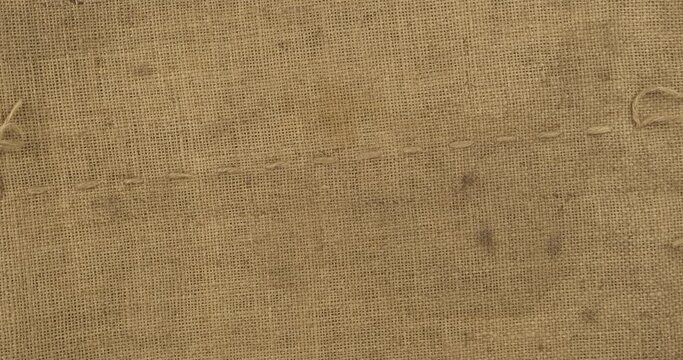 Rotation of the natural linen fabric of the sack. Texture, background. Top view
