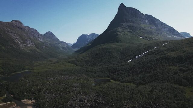 Scenic View Of Pointy Mountain And Lake In Innerdalen Valley, Norway - aerial drone shot