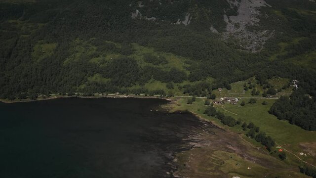 Aerial View Of Lush Green Vegetation, Field And Lake In Innerdalen, Norway - drone shot