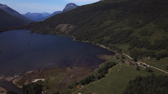 Lake And Lush Green Landscape near Innerdalen Valley In Sunndal, More og Romsdal, Norway. aerial orbit