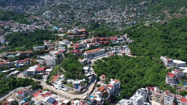 Aerial wide angle above Acapulco at Mexico city at day, dolly out