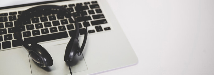 Laptop computer and headphone on desk, e-learning online, webinar for education and learning,...