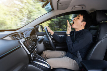 tired man yawning and sleepy while driving car - obrazy, fototapety, plakaty