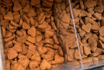 Bulk bin dog treats at a pet store. Bin full ofdog biscuit treats. 