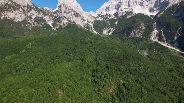 Wild forest and beautiful mountain with high peaks covered in snow, Valley of Valbone in Albania