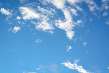 Naklejka na ściany i meble Horizontal view with white small clouds against blue sky