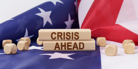 The American flag has wooden cubes and plaques that say - CRISIS AHEAD