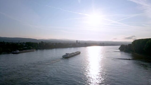 Drone clip over the Rhine river on a clear day with a river boat in the middle in Germany close to Koblenz