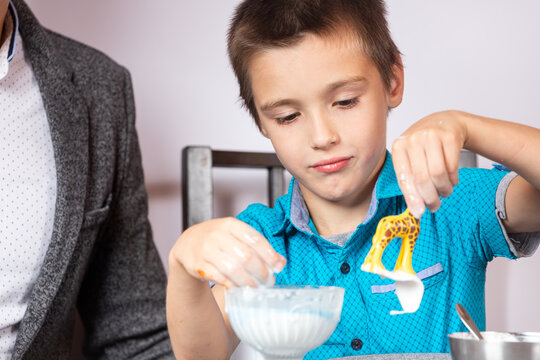 Chemistry Education And Training Concept. Close-up Of A Boy And His Dad Making A Home Experience, Making A Non-Newtonian Liquid From Starch And Water