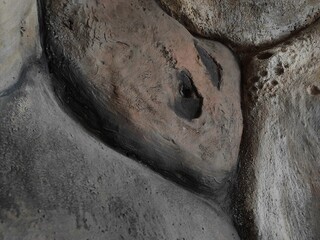 a stone wall shaped like a rock in a cave