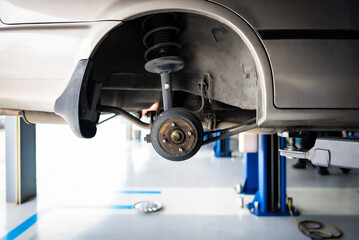 Car repairing or changing wheel in auto repair shop