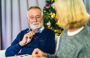 Senior happy love elder couple relaxing and talking together lying on sofa in bedroom at home.Retirement healthcare couple concept