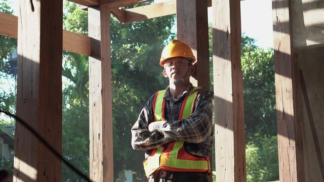 Carpenter Young Asia  Standing Crossed Arms Smile In Furniture Factory. Happy Young Attractive Carpenter Wearing Plaid Shirt Standing With Crossed Arms Smiling And Looking To Camera.