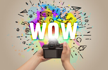 Close-up of a hand holding digital camera with abstract drawing