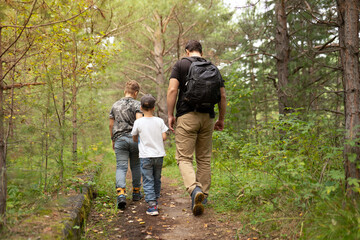 Naklejka na ściany i meble Family hiking in the woods