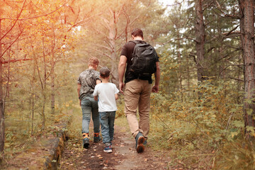 family walking in the woods