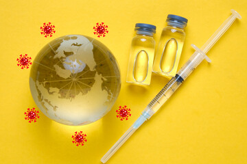 A picture of Covid-19 vaccine and syringe with covid-19 orbitting the globe. Get protected with vaccine from new variant.