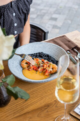 woman eating black rice with shrimps