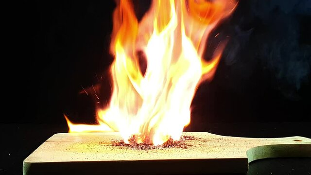Experiment using Potassium permanganate KMnO4 and Sugar. Potassium permanganate and sugar can start a fire. Image on black background