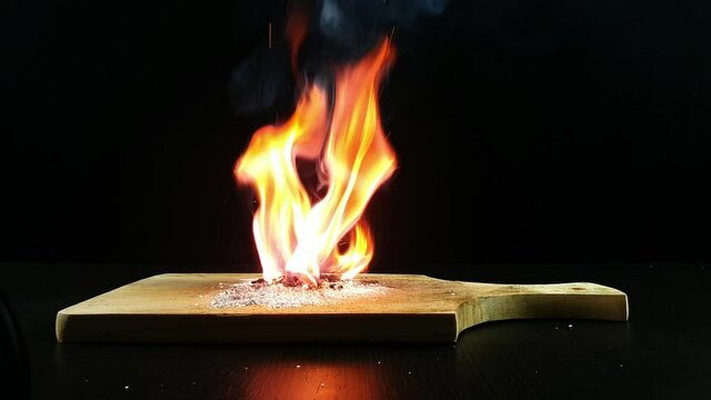 Experiment using Potassium permanganate KMnO4 and Sugar. Potassium permanganate and sugar can start a fire. Image on black background