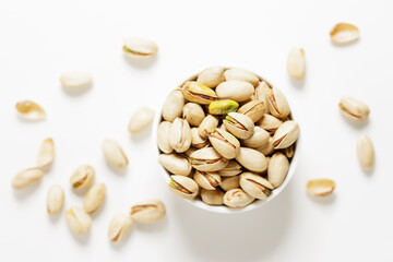 bowl with pistachios on white background