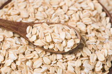 oat flakes or oatmeal in a spoon