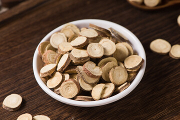 Chinese herbal medicine, sliced of dry Licorice on wooden background
