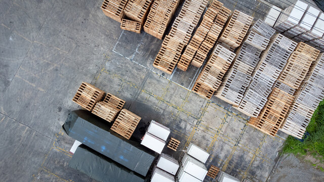 Warehouse with many containers and stockpile in cargo hold. Photo storeshouse from aerial view.