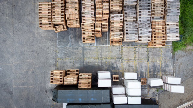 Warehouse with many containers and stockpile in cargo hold. Photo storeshouse from aerial view.