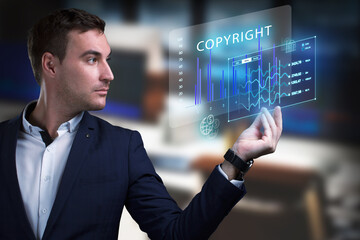 Business, Technology, Internet and network concept. Young businessman working on a virtual screen of the future and sees the inscription: Copyright