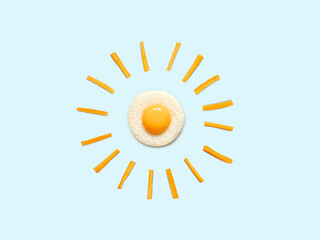 egg and carrots create the sun. Healthy breakfast idea concept.